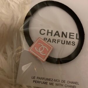 Chanel hair tie, with pink CC square.  The band is extra tight and will last!